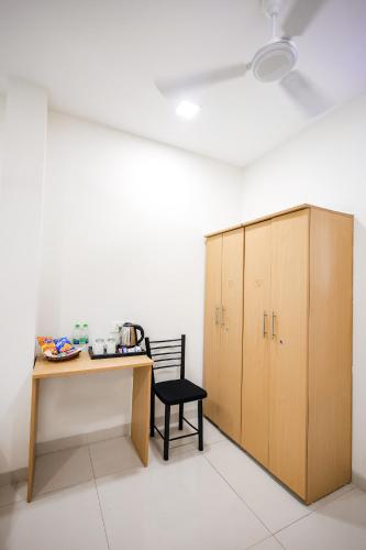 a room with a desk and a chair and a cabinet at Hotel Konark Nest-Vijay Nagar in Indore