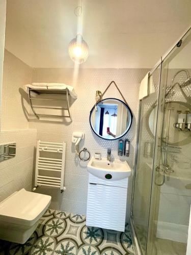 a bathroom with a sink and a shower and a mirror at REGINA Bed&Wine in Varna City