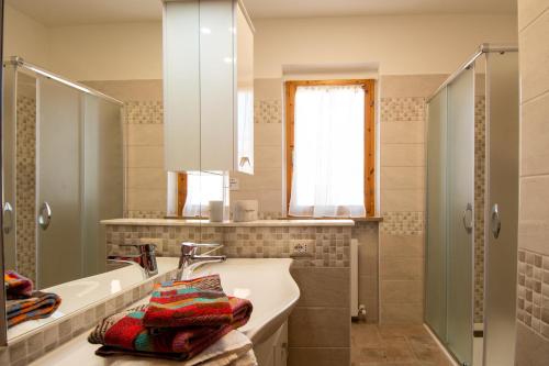 a bathroom with a sink and a mirror and a tub at La Casa Sul Lago - SlowLife in Passignano sul Trasimeno