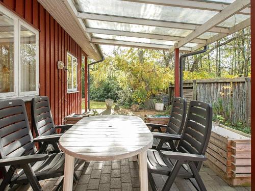 a wooden table and chairs on a patio at Beachside Haven in Marielyst - By Traum Ferienwohnungen in Marielyst