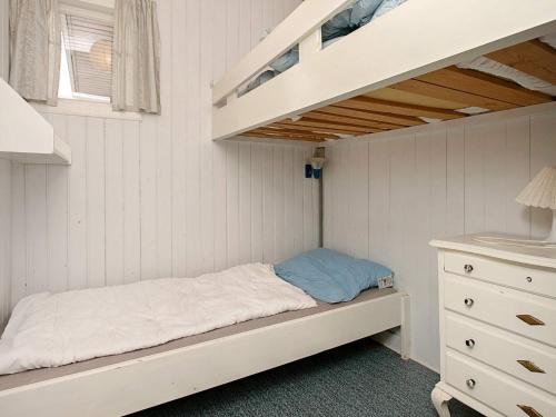 a bedroom with a bunk bed and a ladder at Beachside Haven in Marielyst - By Traum Ferienwohnungen in Marielyst