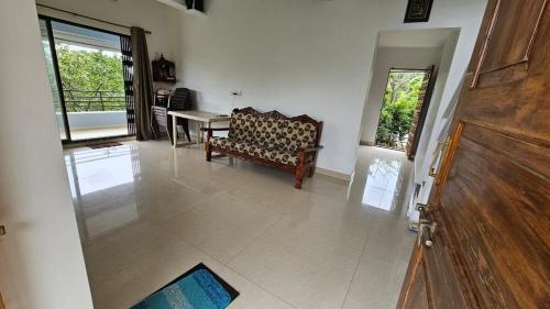 a living room with a couch and a table at Nakshatra in Sawantwadi