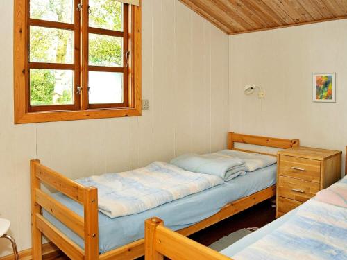 a bedroom with two twin beds and a window at 4 person holiday home in Haderslev-By Traum in Diernæs