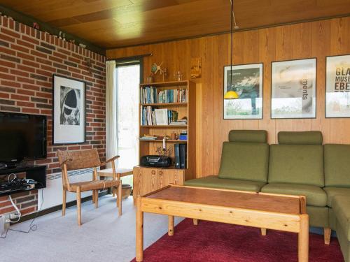 a living room with a couch and a tv at 6 person holiday home in Ebeltoft-By Traum in Ebeltoft