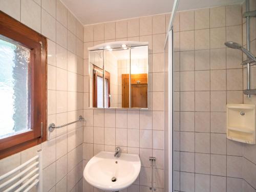 a white bathroom with a sink and a mirror at Chalet in Kalchberg near Klippitztörl Ski in Bad Sankt Leonhard im Lavanttal