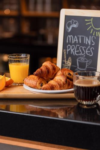 a plate of pastries and a glass of orange juice at ibis Montélimar Nord in Saulce-sur-Rhône