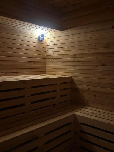 a wooden sauna with a light on the wall at Class Unique Beach in Marmaris