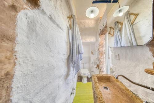 a bathroom with a sink and a toilet in a room at Guest House Fontanelle in Ugento