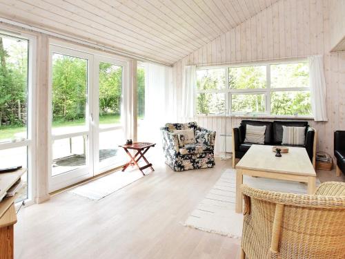 a living room with a couch and a table at 4 star holiday home in Ålbæk in Bunken
