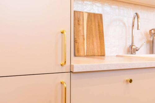 a kitchen with a sink and a counter top at Le Sassenay in Dijon