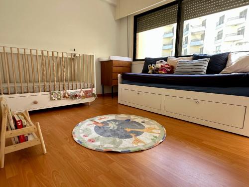 a baby room with a crib and a baby crib at "99 steps to the beach" Beachfront apartment with Kids Room, Pool & 2 Workspaces in Limassol