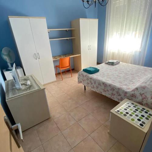 a bedroom with a bed and a table and a chair at CAMERE DI ARHET in Parma