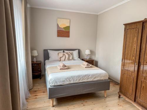 a bedroom with a bed with two towels on it at Pie Jūras in Saulkrasti