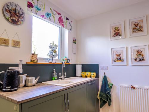 a kitchen with a sink and a window at The Highlander in Dornie
