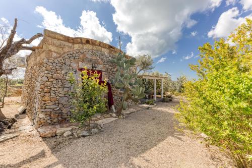 a stone building with a cactus in front of it at Guest House Fontanelle in Ugento