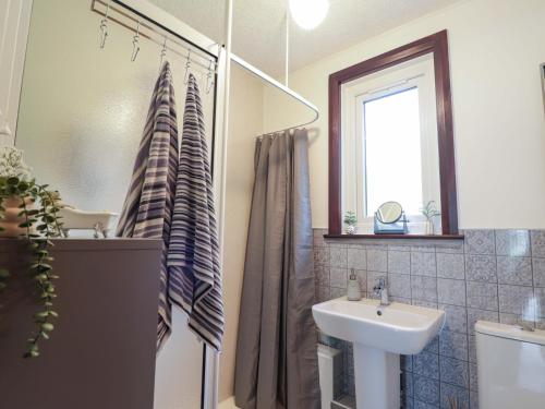 a bathroom with a sink and a shower at The Highlander in Dornie