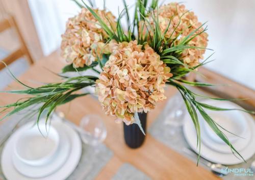 a vase filled with flowers on a table at 5BR House, Sleeps 10 guests - Free Parking - Great for Professionals & Contractors in Pontefract