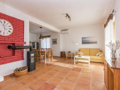a living room with a clock on the wall at Holiday Home in Zemunik Donji with Pool in Donji Zemunik
