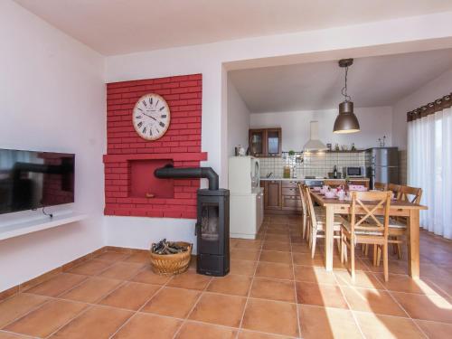 a kitchen and dining room with a red brick wall at Holiday Home in Zemunik Donji with Pool in Donji Zemunik