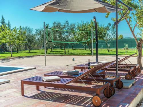 a picnic table with an umbrella next to a pool at Holiday Home in Zemunik Donji with Pool in Donji Zemunik