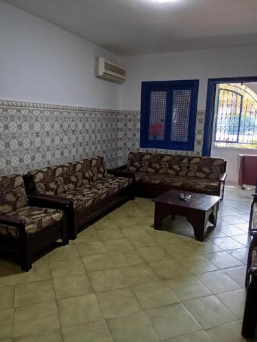 a living room with couches and a coffee table at cozy place in Monastir