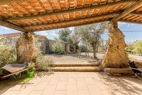 an outdoor patio with a wooden pergola at Guest House Fontanelle in Ugento