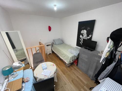 a living room with a room with a bed and a table at Room in city Nice in Nice