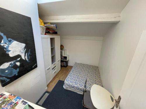 a small room with a bed and a tv at Room in city Nice in Nice