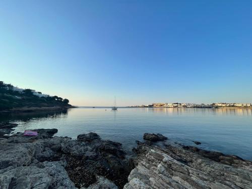 a large body of water with rocks in the foreground at Art Sounion, Seafront Elegance in Sounio
