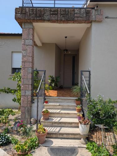 a stairway leading to a house with potted plants at Casa MAM 