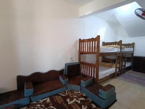 a living room with two bunk beds and a couch at Elif Dorms in Dahab