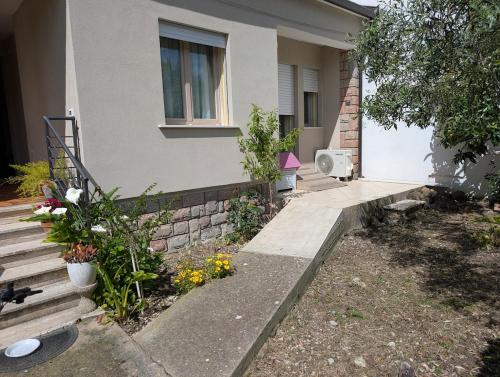 a house with a porch and stairs in front of it at Casa MAM 