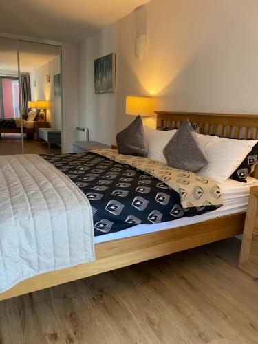 a bedroom with a large bed with white sheets and pillows at California Building in London
