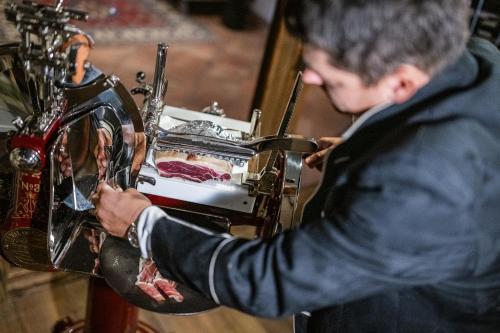 a man is making food in a machine at Alpenwellnesshotel St. Veit in Sesto