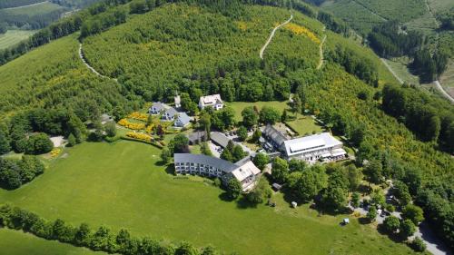 an aerial view of a large house on a green field at Berghotel Hoher Knochen - Ruhe & Natur in Winterberg