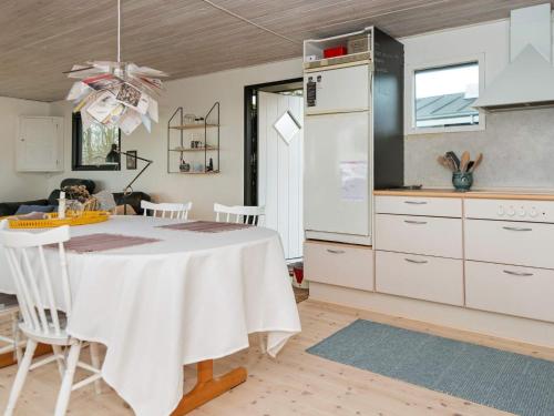 a kitchen with a white table in a room at 5 person holiday home in Juelsminde-By Traum in Sønderby