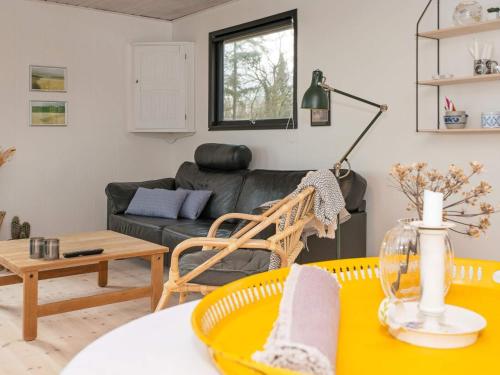 a living room with a couch and a table at 5 person holiday home in Juelsminde-By Traum in Sønderby