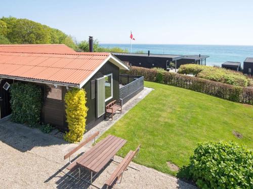 a building with a picnic table and a bench at 5 person holiday home in Juelsminde-By Traum in Sønderby