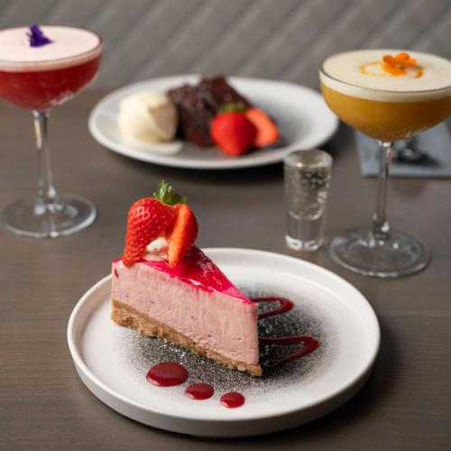 a piece of cake on a plate with two desserts at Royal Hotel in Cumnock