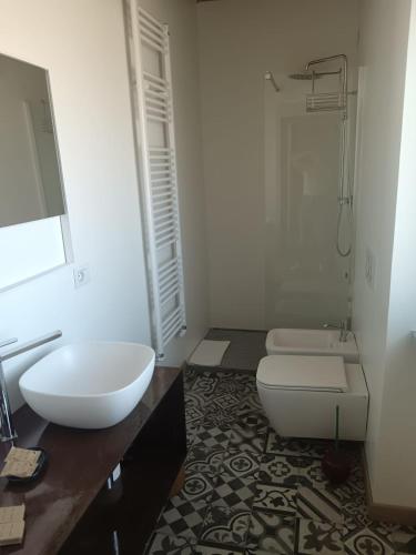 a bathroom with a white toilet and a sink at Langhe & Wine Accommodation in Neive