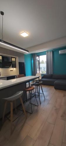 a living room with a table and some chairs at Apartments Black Pearl of Ureki in Ureki