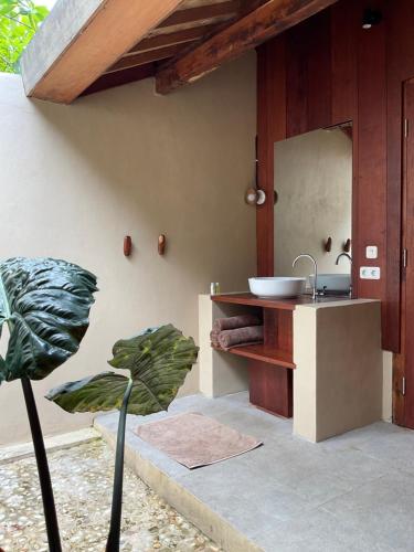 a bathroom with a sink and a mirror at Tumbuh Oasis in Letman