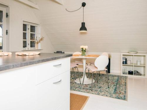 a kitchen with a table and chairs in a room at 4 person holiday home in Børkop in Børkop