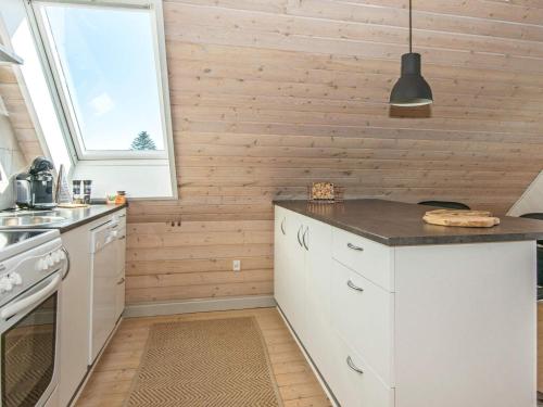 a kitchen with white cabinets and a window at 4 person holiday home in Børkop in Børkop