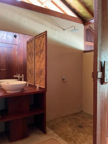a bathroom with a sink and a mirror at Tumbuh Oasis in Letman