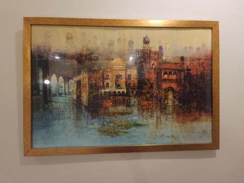 a painting of a building on a wall at Aspire Lodge, G11 Islamabad - A Family Guest House & Hotel in Islamabad
