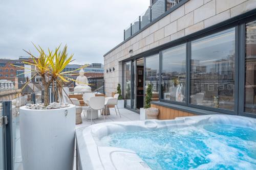 a hot tub on the balcony of a building at SAINT PAUL - Unrivalled 3BR Penthouse Apartment with Hot Tub Leeds in Leeds