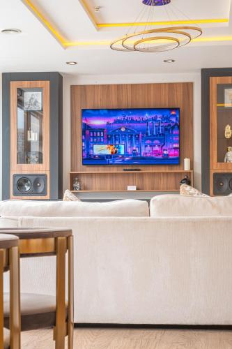 a living room with a couch and a tv at SAINT PAUL - Unrivalled 3BR Penthouse Apartment with Hot Tub Leeds in Leeds