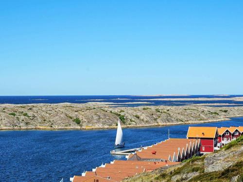 a dock with a sail boat in the water at 5 person holiday home in KUNGSHAMN in Kungshamn