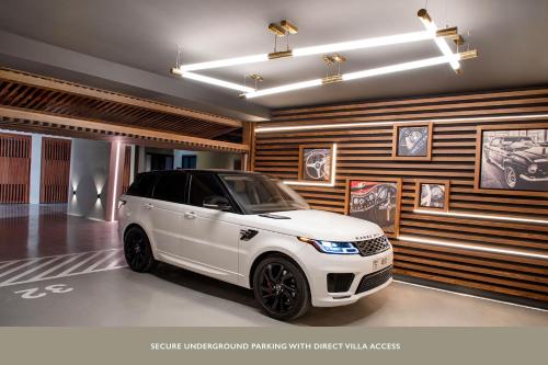 a white car is parked in a garage at The Biltmore Hotel Villas, Dubai in Dubai